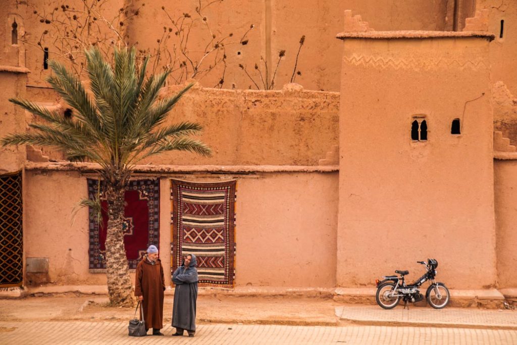 This couple chatting in Ouarzazate, Morocco, is a beautiful symbol of two quintessential images of the Sahara desert that stretches behind the city. 