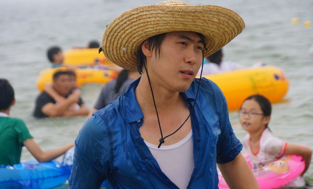 A candid shot of a Korean man wearing a 'distinct' Korean style cowboy hat near the beach in Daecheon, South Korea