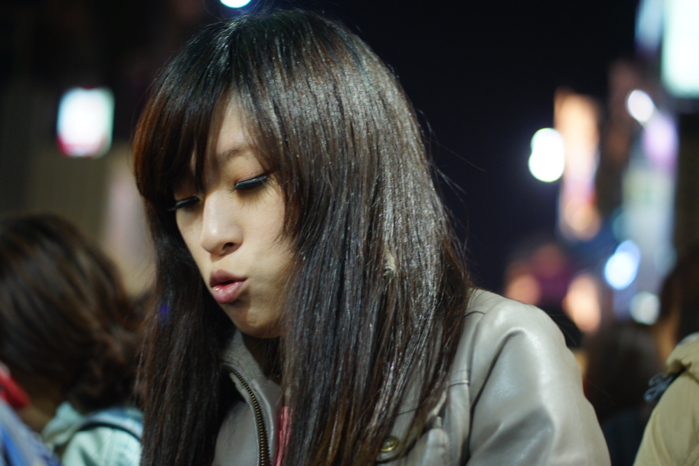 A candid shot of a Taiwanese lady with a distinct face at the night market in Taiwan