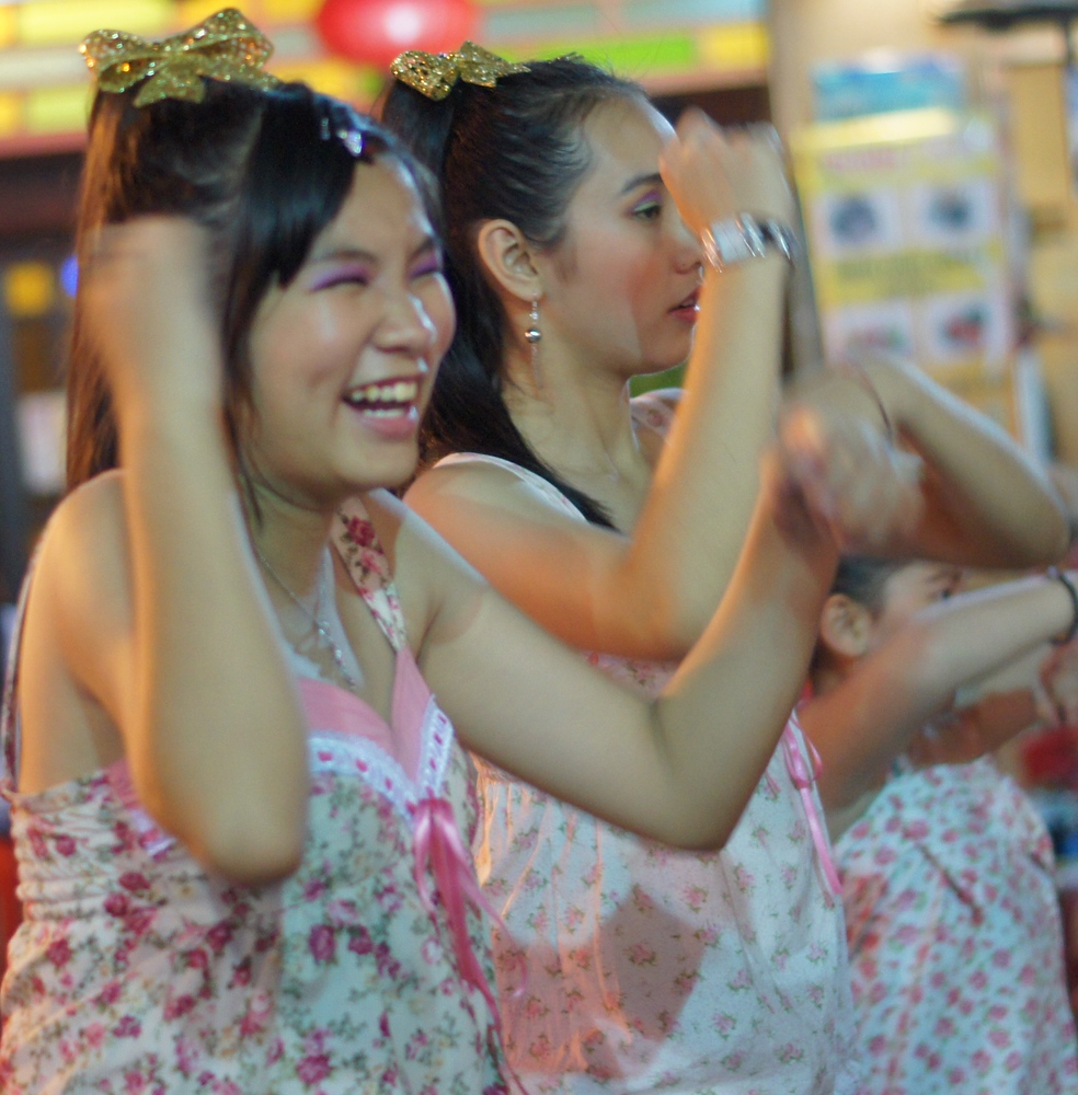 A candid shot of some girls laughing while performing a dance. These girls really were enjoying putting on a show in Malacca, Malaysia