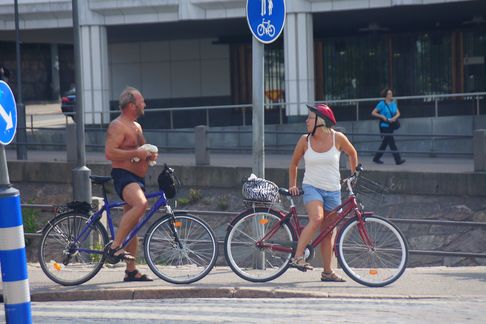 A couple stop for a quick break while biking around Helsinki