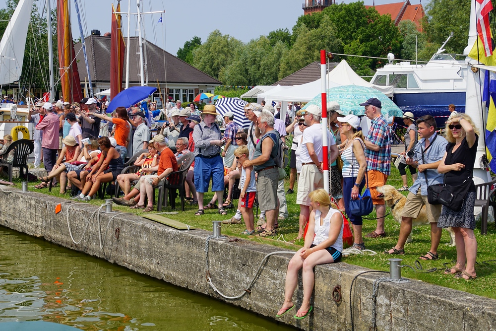 A crowd of lively German spectators cheering on participants of the Regatta in Wustrow, Germany
