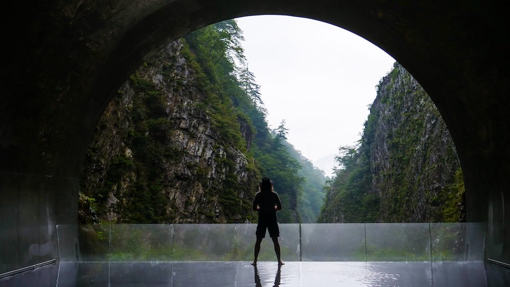 A day trip to Kiyotsu Gorge is a must attraction with Nomadic Samuel posing at the Tunnel of Light