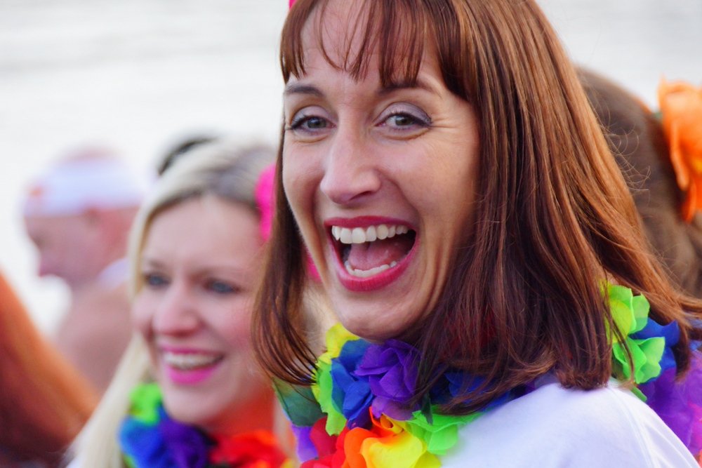 A delighted smile of a lady enjoying the Loony Dook in Scotland