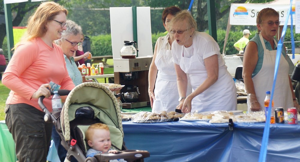 A family stopping at the concession stand to by Scottish foods such as Haggis and Irn Bru at the Fredericton Highland Games