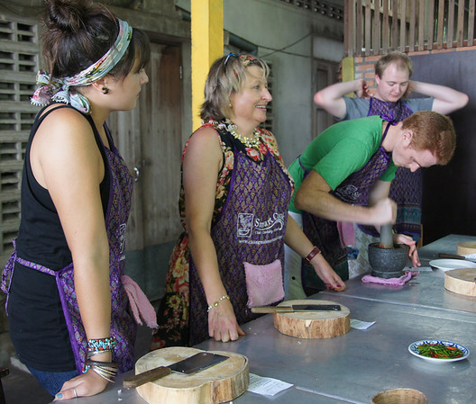 A group of us making curry paste including Nomadic Samuel during the Thai cooking course in Chiang Mai, Thailand