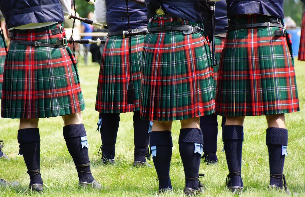 A group shot of men wearing kilts at the New Brunswick Highland Games