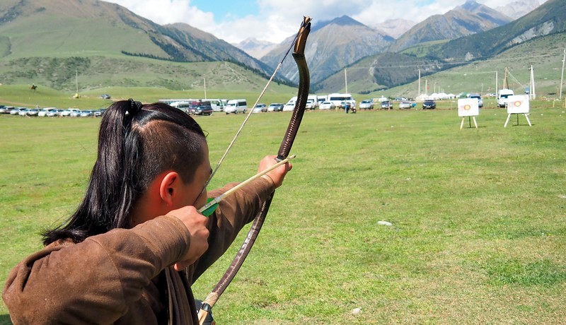 A man practicing archery at the competition in Kyrgyzstan. Can you feel the concentration?