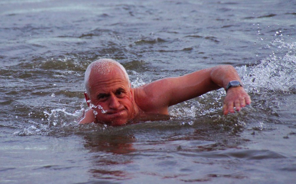 A man very confidently and bravely swims in the Firth of Forth during Loony Dook