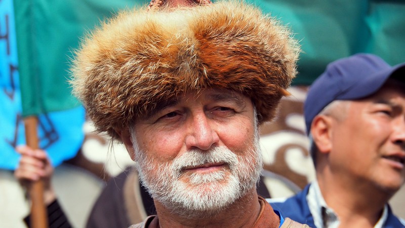 A man wearing a distinct hat at the Kyrgyzstan games. I want one of those!