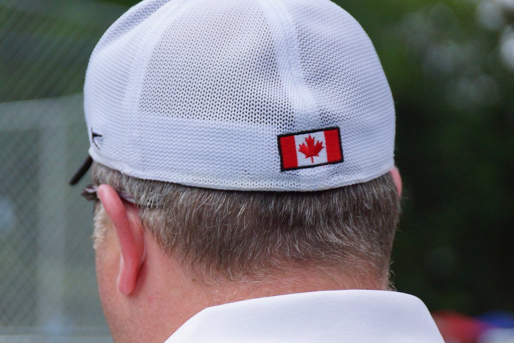 A man wearing a hat with a Canadian flag at the New Brunswick Highland Games in Fredericton