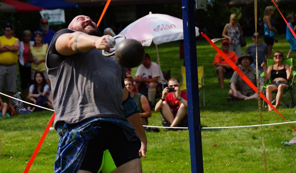 A mountain of a man prior to releasing the weight over his head at the Highland Games in Fredericton, New Brunswick, Canada