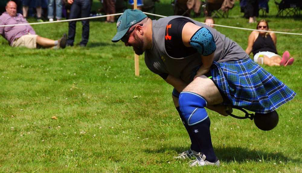 A side angle shot of an athlete warming up for the weight for height event at the New Brunswick Highland Games