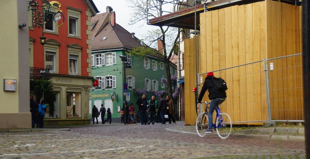 A typical scene from the Old Quarter in Freiburg as pedestrians and bicycles dominating versus traffic from vehicles in Germany