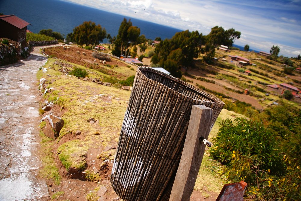 A waste basket made out of wood frames this shot of the island 