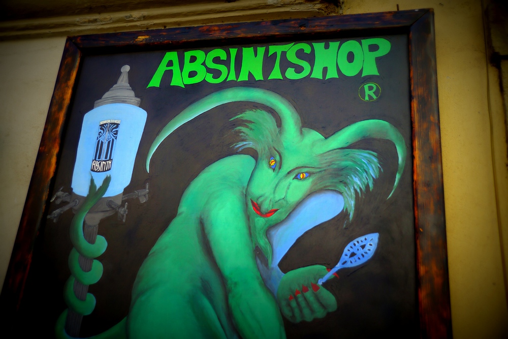 Absinthe poster with a green demon in Prague, Czech Republic