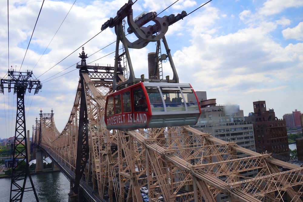 Aerial views of New York City on the Roosevelt Island Tramway crossing over a bridge