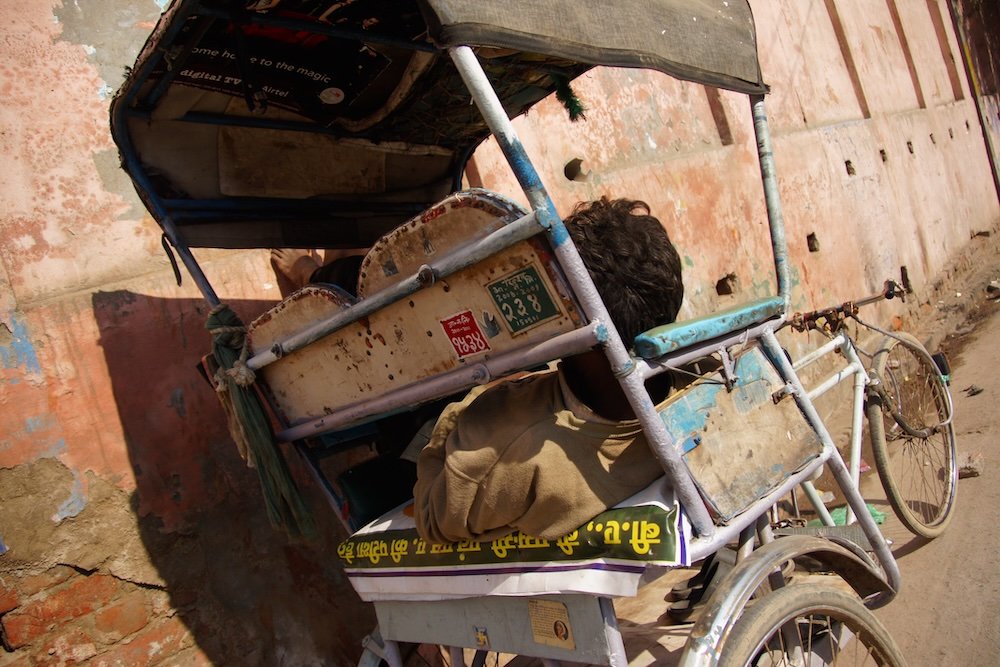 Agra rickshaw parked with driver sleeping 