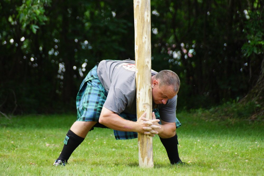 An athlete picking up the caber at the New Brunswick Highland Games