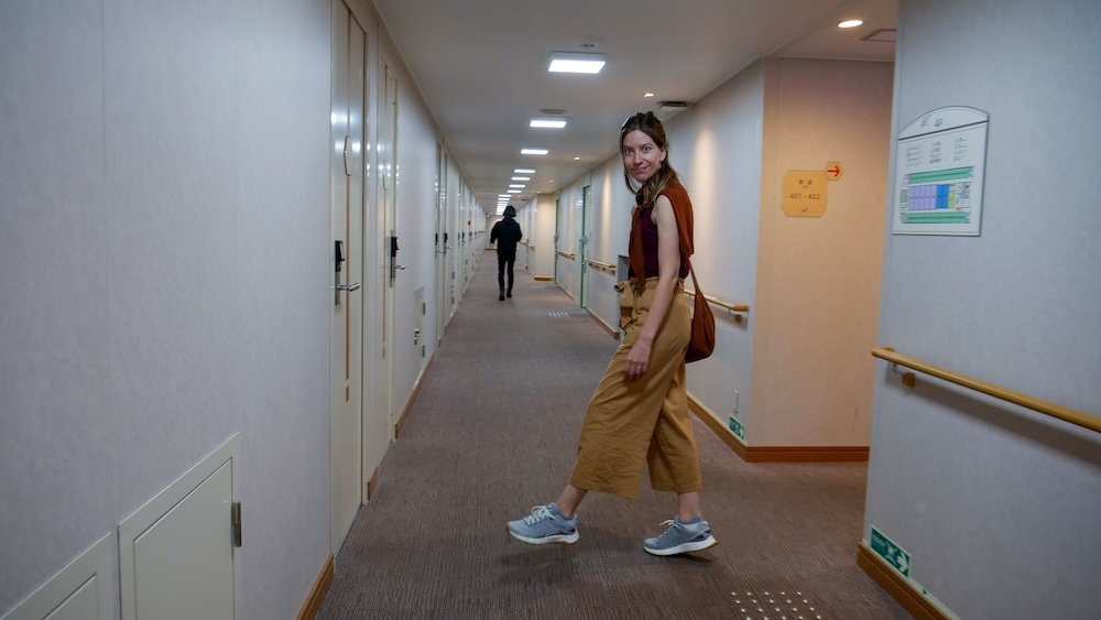 Audrey Bergner exploring the hallway of rooms on board a Japanese ferry