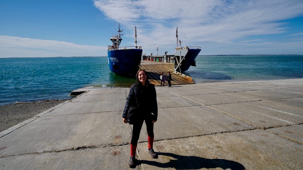 Audrey Bergner at the First Angostura Ferry Crossing in Tierra del Fuego Audrey Bergner stands beside the First Angostura ferry during the overland journey between Punta Arenas and Ushuaia across Tierra del Fuego.