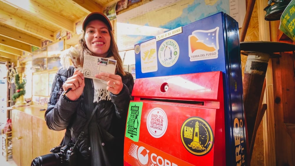 Audrey Bergner at the Southernmost Post Office in Ushuaia, Tierra del Fuego Audrey Bergner smiles while holding a stamped postcard beside the southernmost post office in Ushuaia, Tierra del Fuego, Argentine Patagonia.