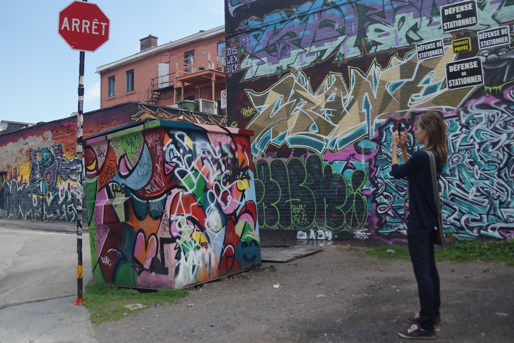 Audrey Bergner taking a photo of Montreal street art and graffiti