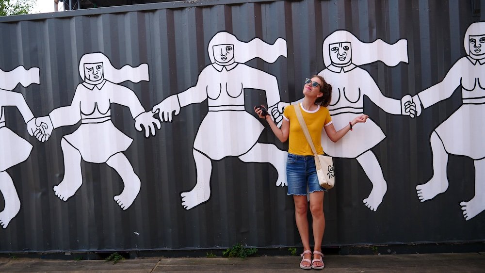 Audrey Bergner That Backpacker excited to be visiting Poznan, Poland posing by an art instillation found in the city