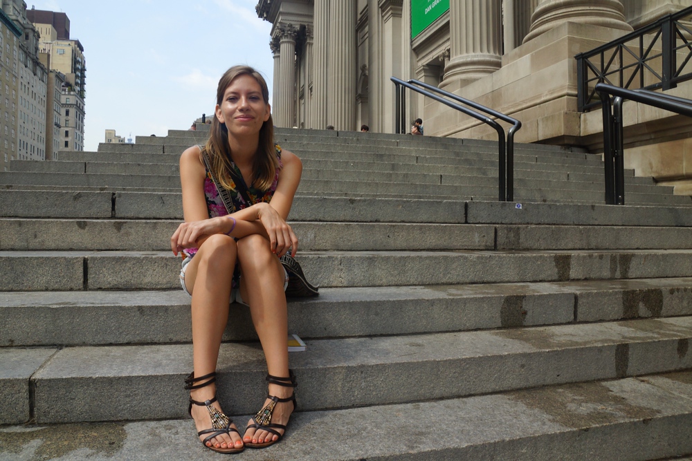Audrey Bergner ‘That Backpacker’ sitting on the steps outside of the MET Museum in New York City