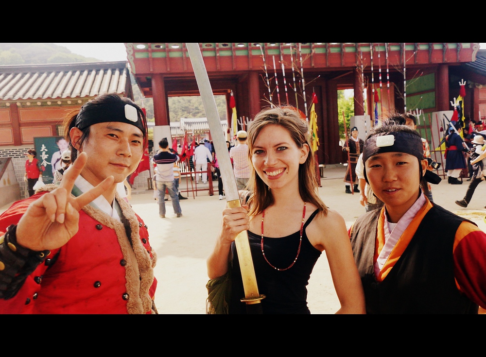 Audrey Bergner (That Backpacker) wielding a sword with some Korean martial artist performers