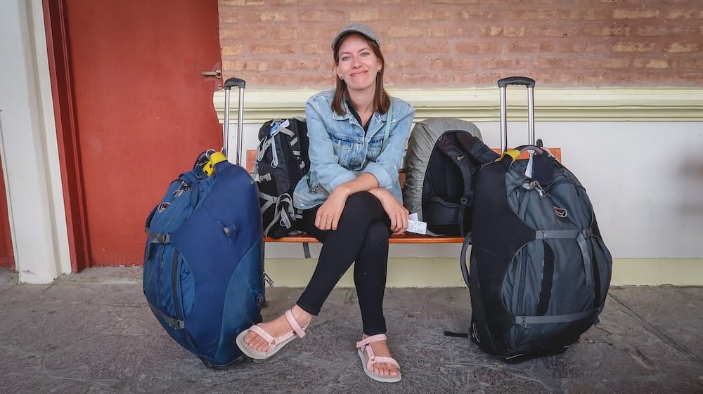 Audrey Bergner Waiting to Board a Bus in Trelew, Chubut, Patagonia, Argentina Audrey Bergner sits on a bench with large travel bags and backpacks while waiting to board a long-distance bus in Trelew, Chubut, Patagonia, Argentina, holding her ticket beside the packed luggage.