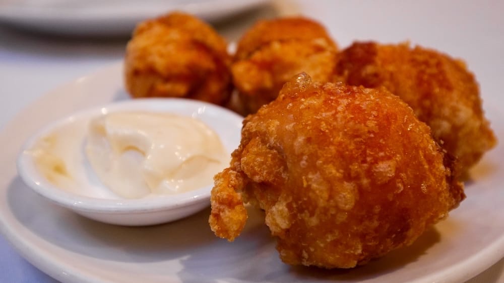 Bacon-Wrapped Deep-Fried Shrimp at Silver Dragon Restaurant, Chinatown, Calgary, Alberta, Canada Bacon-wrapped deep-fried shrimp with a crispy golden coating, served on a plate with a creamy dipping sauce at Silver Dragon Restaurant in Chinatown, Calgary, Alberta, Canada.
