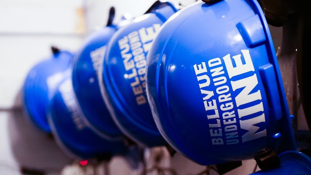 Bellevue Underground Mine Tour in the Crowsnest Pass, Alberta, showing a row of blue safety hardhats lined up before an underground visit—an iconic detail of this historic mining experience and a memorable day trip option from Fernie, British Columbia.