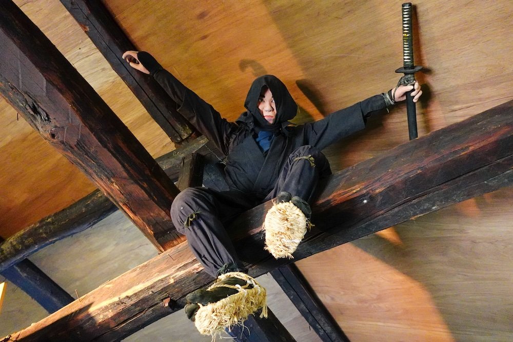 Black ninja coming down from the ceiling with a sword at Togakushi Ninja Folk Village on a day trip from Nagano city, Japan 