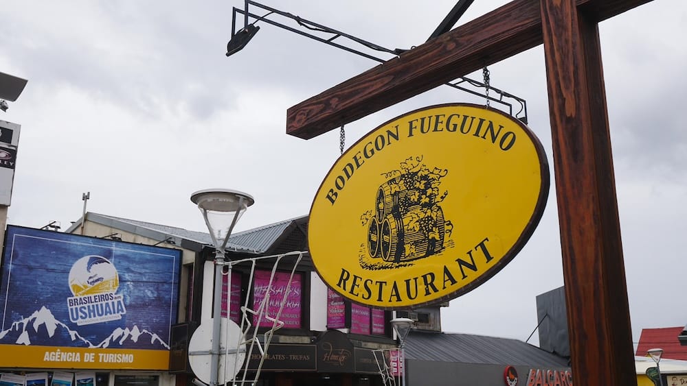 Bodegon Fueguino restaurant sign in Ushuaia Tierra del Fuego Argentina, a popular spot to try cordero fueguino Patagonian lamb, highlighting local dining options at the end of the world where traditional lamb dishes reflect coastal Patagonia terroir