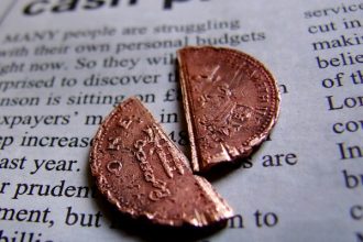 broken penny on newspaper split in half