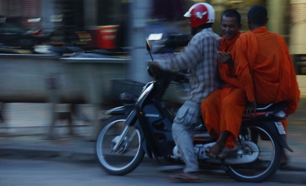 Buddhist monks on motorcycle ride in Battambang, Cambodia 