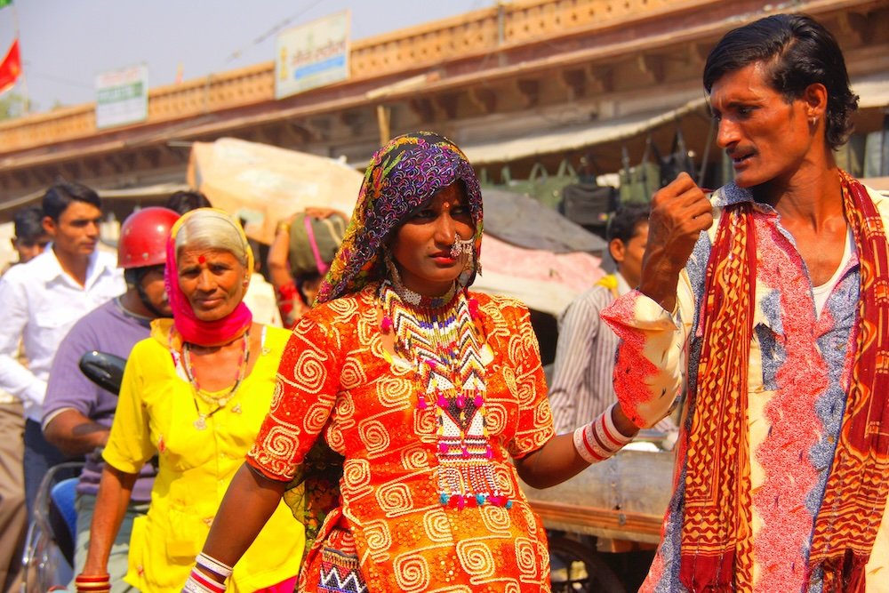 Bustling bazaar life with locals dressed in colorful attire in Jodhpur, India 