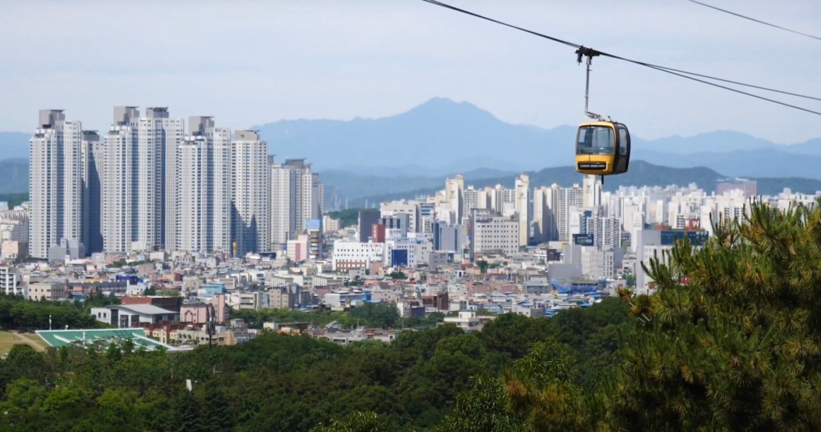 Cable car ride in Daegu, South Korea with apartments in the background 