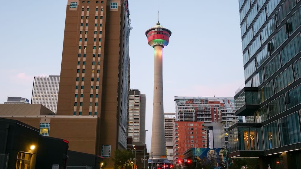 Calgary Tower Downtown Alberta Canada Evening Landmark and Car-Free City Centre Sightseeing Calgary Tower rises between high-rise buildings in Downtown Calgary, Alberta, Canada, at dusk, with city streets and illuminated building windows framing the landmark.