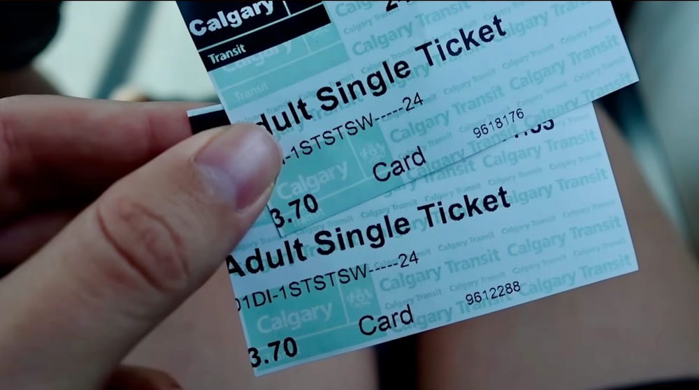 Calgary Transit single tickets held by Audrey Bergner en route to Heritage Park, Calgary, Alberta, Canada Audrey Bergner holds two green-and-white Calgary Transit "Adult Single Ticket" fare cards, used for the LRT and bus connection to Heritage Park in Calgary, Alberta, Canada.