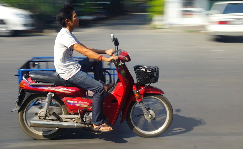 Chiang Mai man on scooter motion blur 