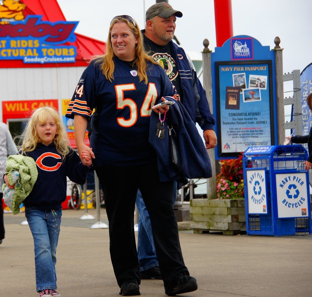 Chicago Bears fans wearing team jerseys and hats strolling along Navy Pier