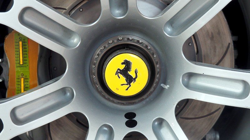 Close-up shot of the Ferrari logo on a wheel at the Enzo Ferrari Museum