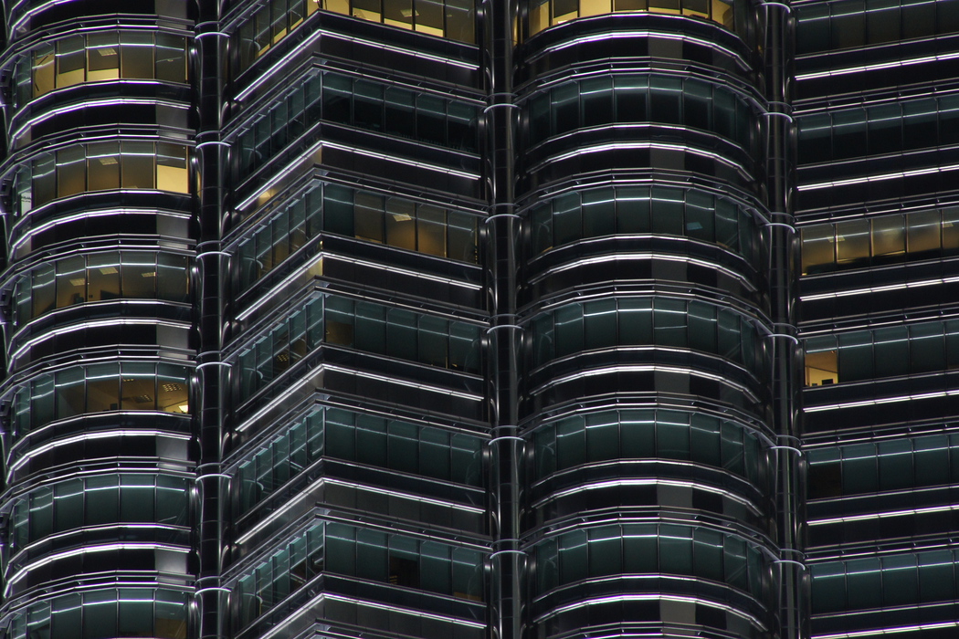 This is a close-up zoomed shot offering a glimpse into the various offices located in the buildings of the Petronas Towers in Kuala Lumpur, Malaysia