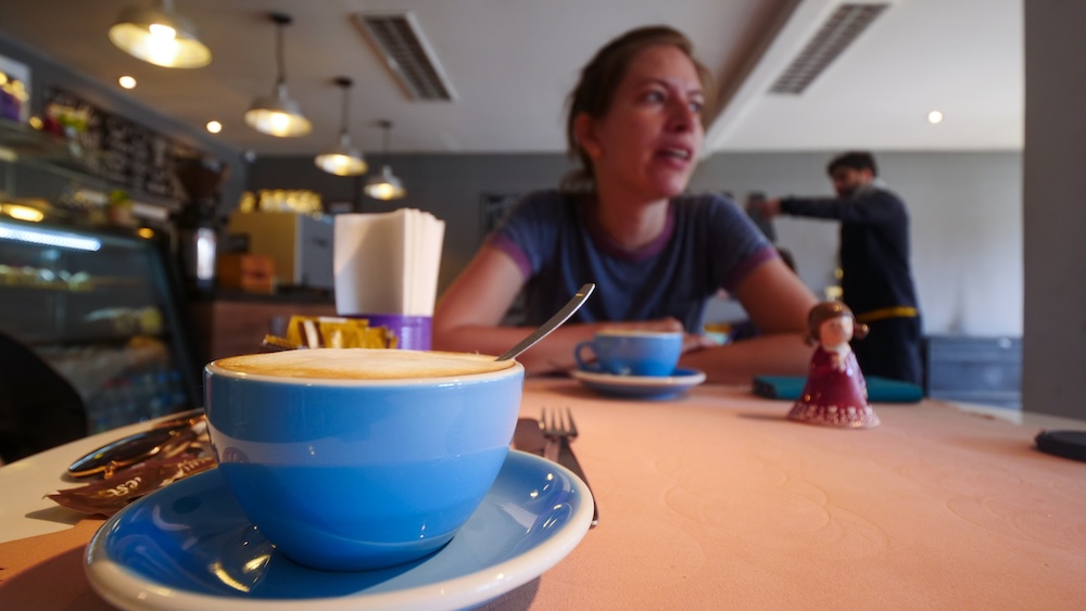 Coffee at Olivia’s café in El Calafate as Audrey Bergner waits for the bus to El Chaltén, a relaxed pre-departure moment where travelers sip cappuccinos and plan their Patagonia hiking adventure.