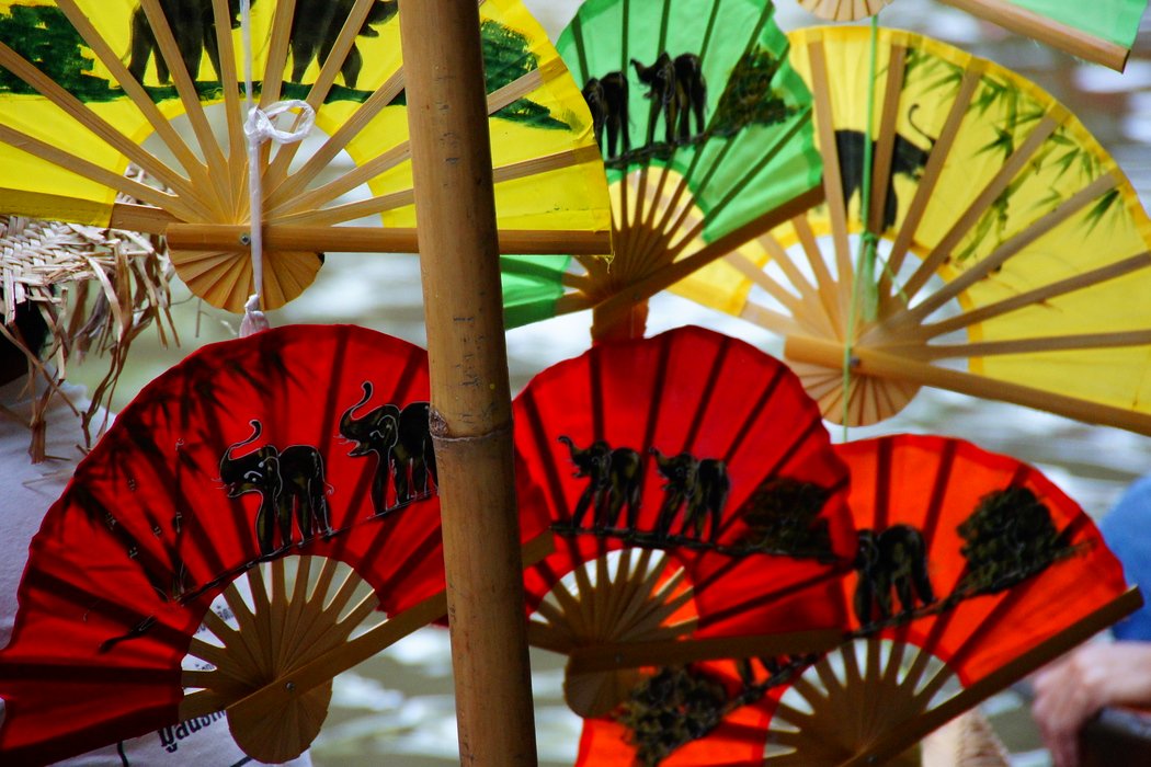 Colorful fans for sale with elephant patterned designs for sale at the Damnoen Saduak Floating Market in Thailand 