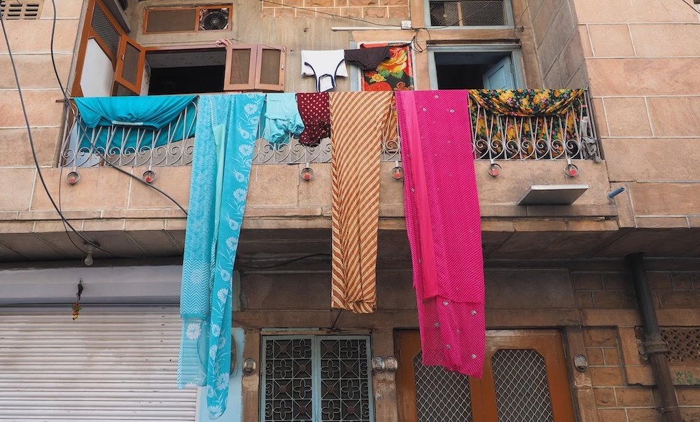 Colorful saris being hung from the balcony in Jodhpur, India 