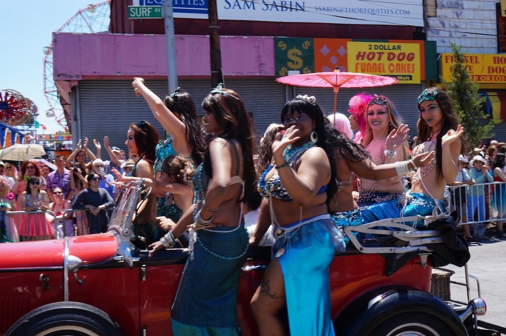 Coney Island Mermaid Parade ladies on the side of a car 