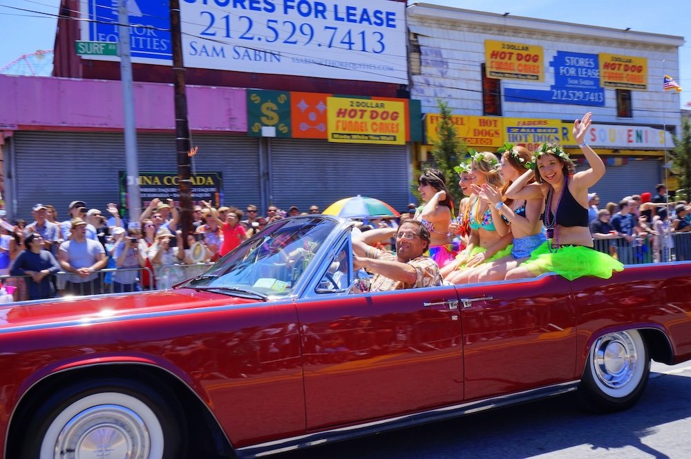 Coney Island Mermaid Parade vintage cars with girls in the back seat 